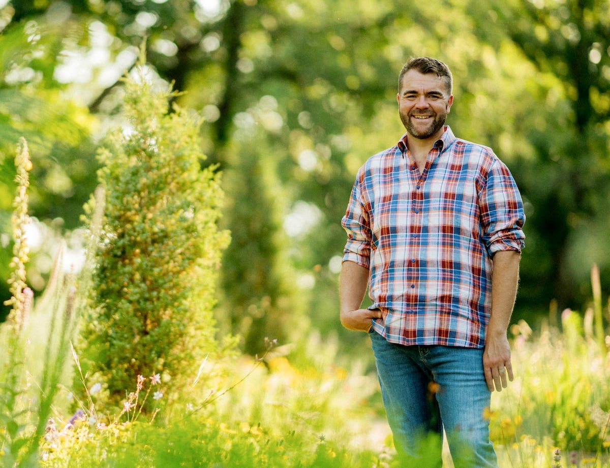 Kelly Norris stands in a garden